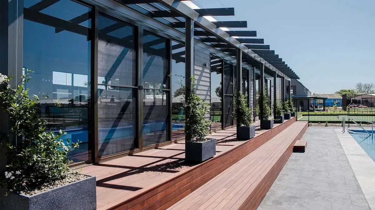 A Large Building With A Swimming Pool In The Background — D&C Projects in Cameron Park, NSW