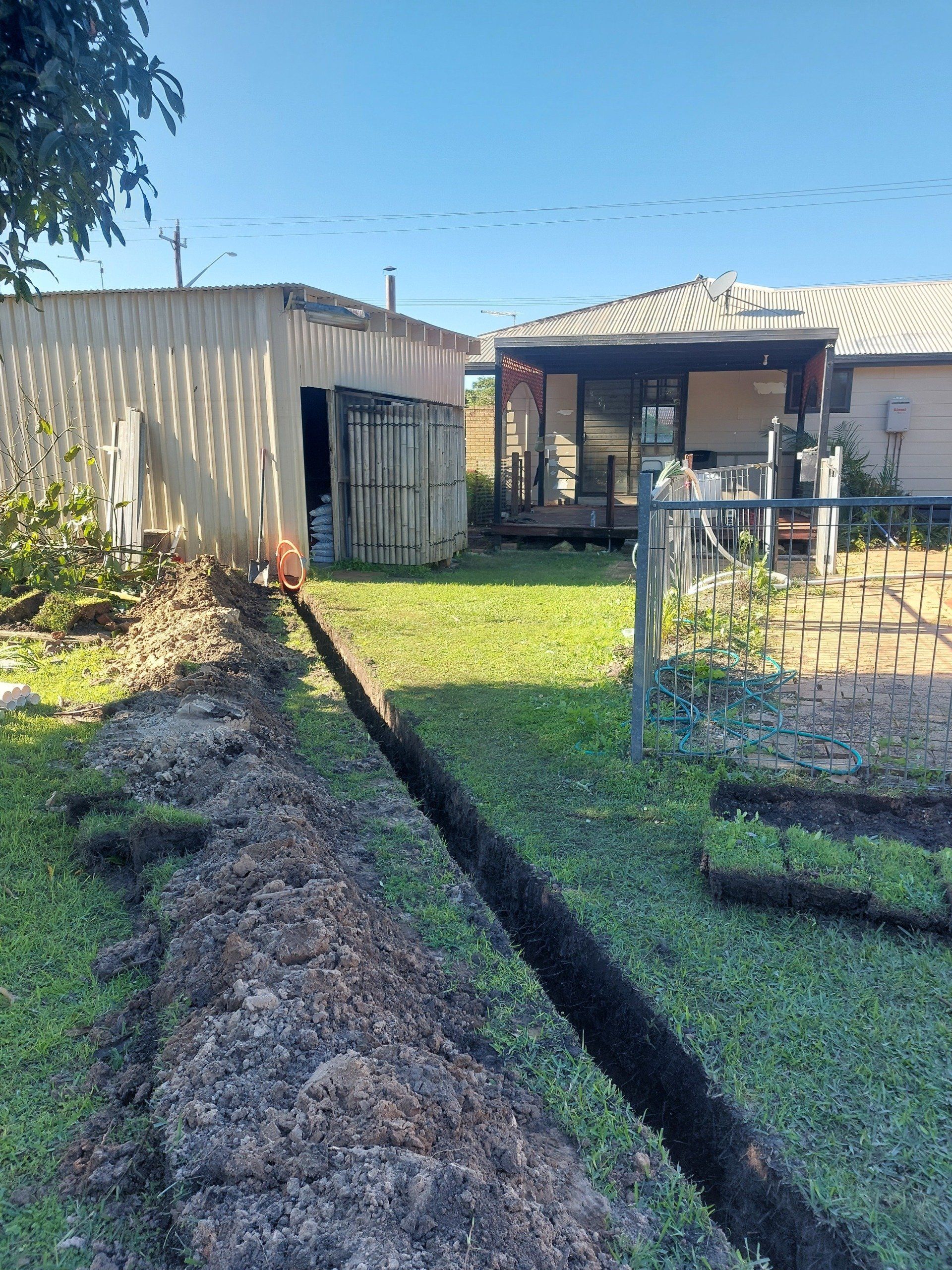 A large pile of dirt is sitting in front of a house.
