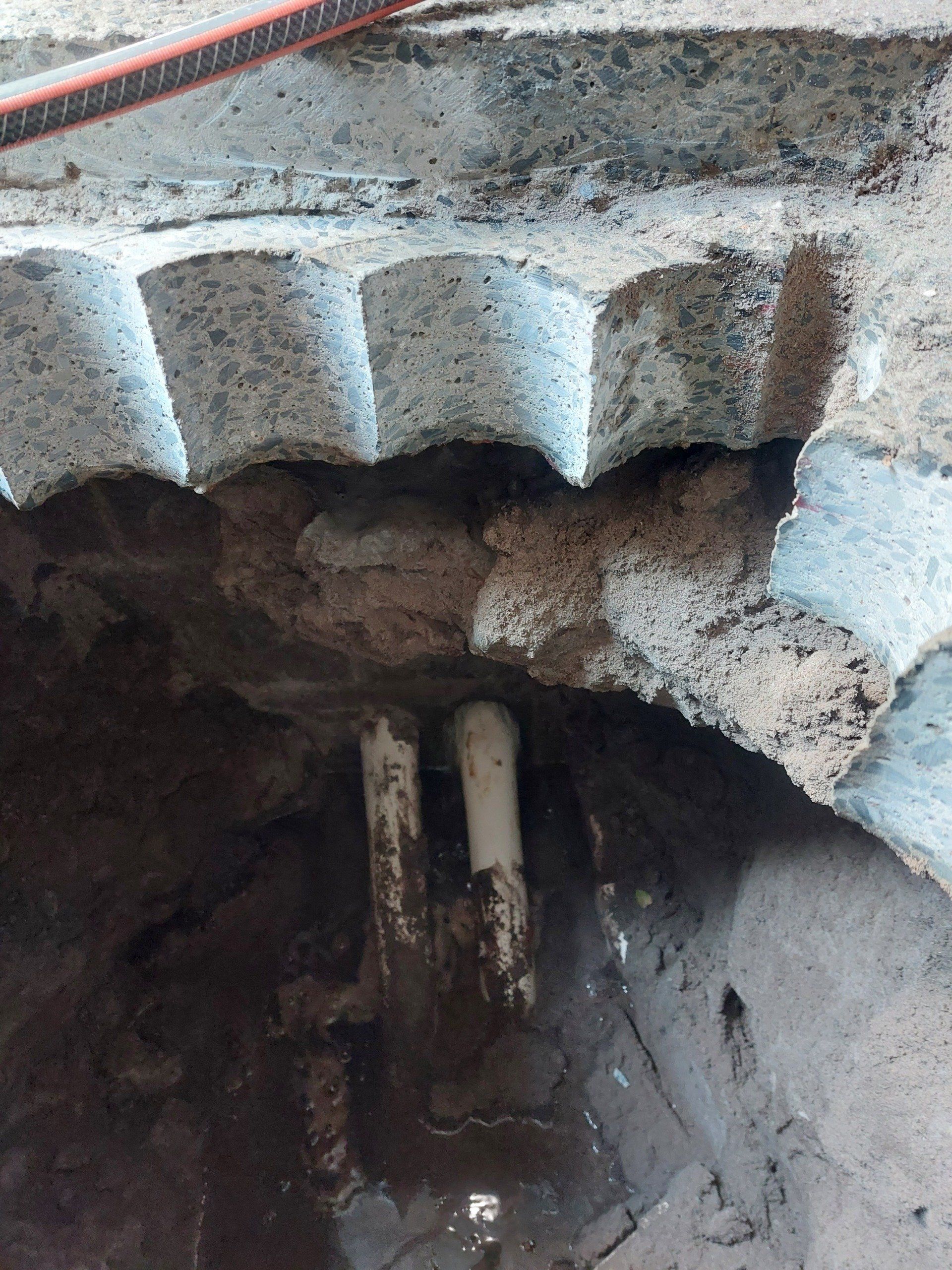 A manhole cover with a pipe coming out of it