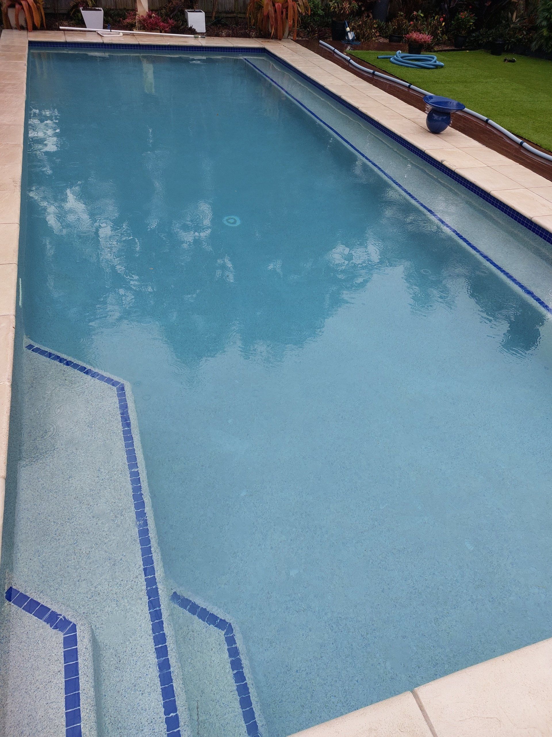 Blue Water Swimming Pool And Cozy Chair — Leak Detection & Swimming Pool Repairs in Ballina, NSW