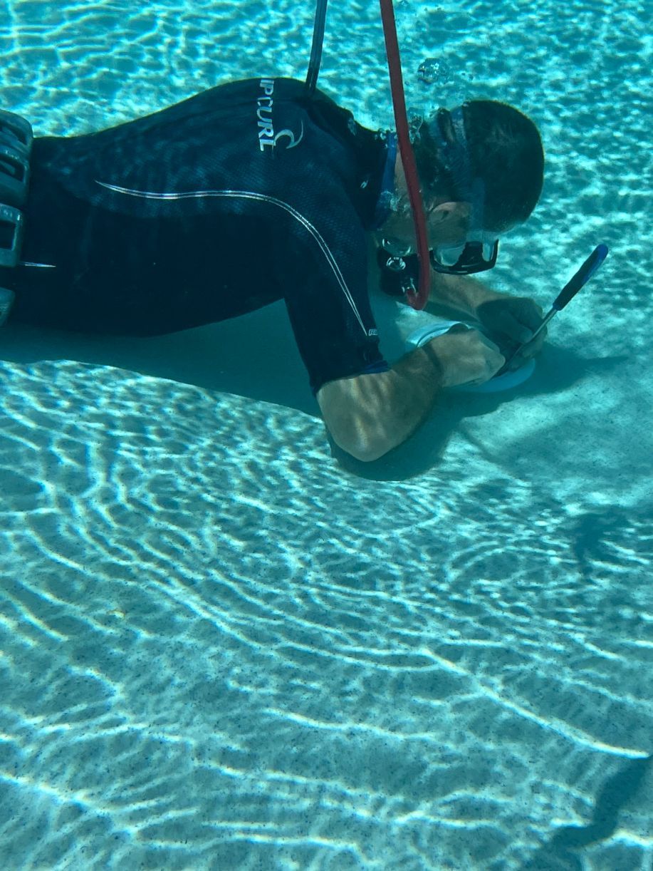 Man Using Tool To Open Drain Hole — Leak Detection & Swimming Pool Repairs in Ballina, NSW