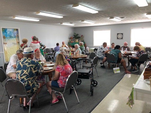 A group of people are sitting at tables in a room