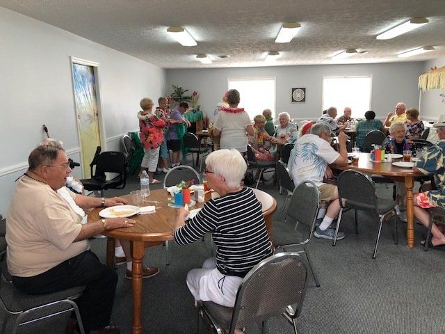 A group of people are sitting at tables in a room