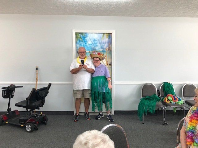 A man and a woman are standing next to each other in a room.