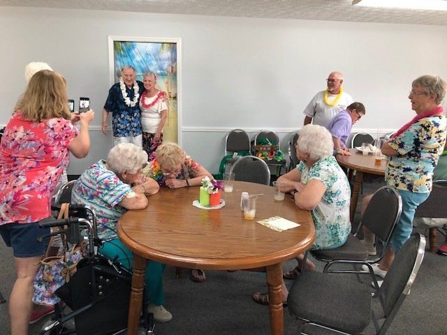 A group of people are sitting around a table in a room.