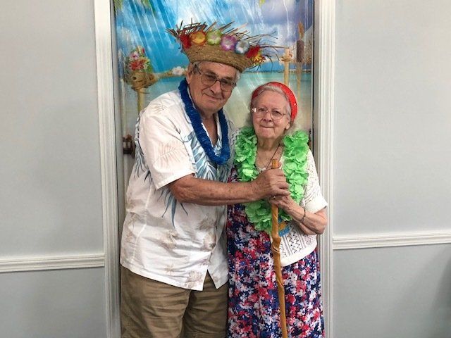 A man and a woman are posing for a picture in front of a door.