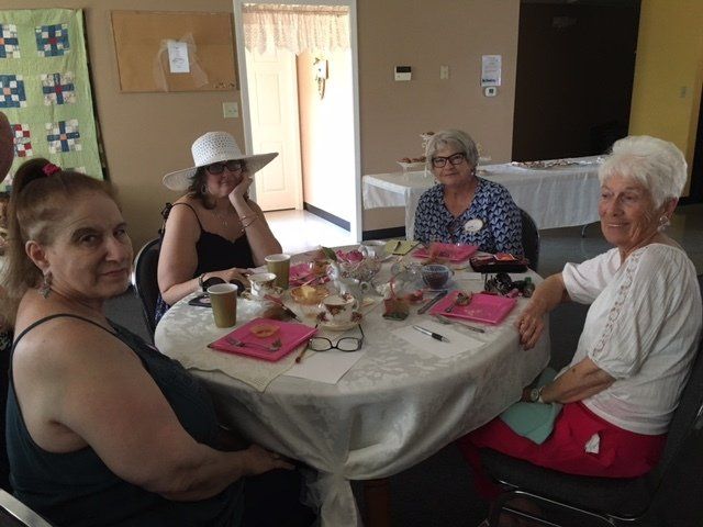 A group of women are sitting around a table