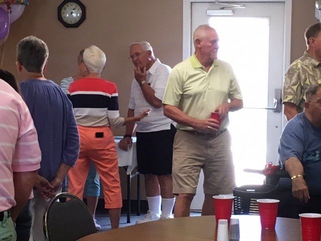 A group of people standing around a table with red cups