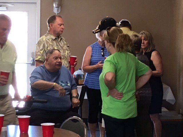 A group of people standing around a table with red cups