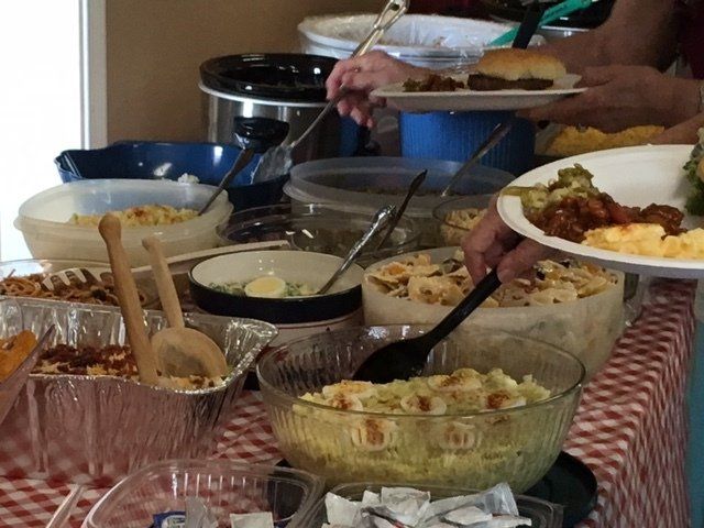 A buffet table with many different types of food on it