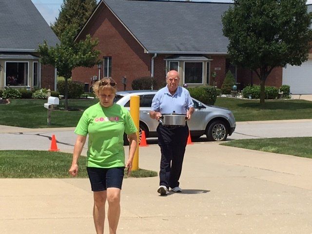 A man and a woman are walking down a street