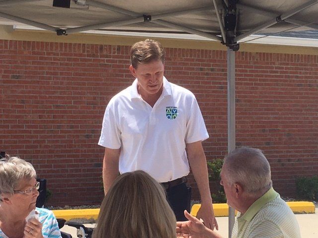 A man in a white shirt with the word city on it