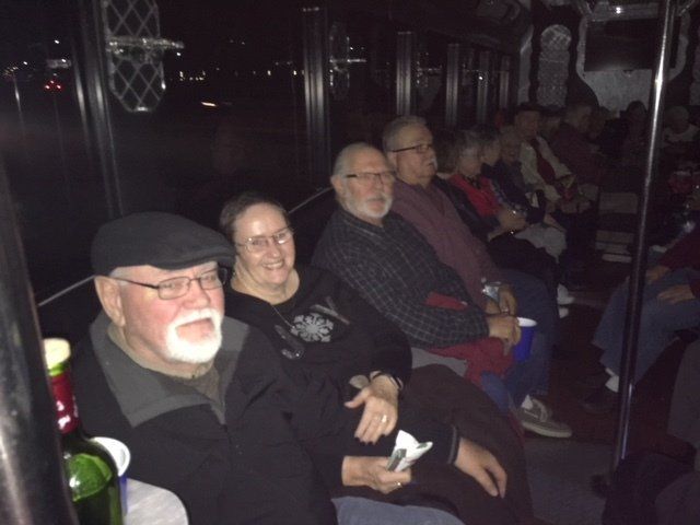 A group of people are sitting in a dark room