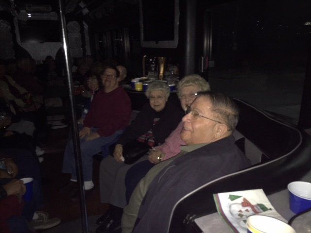A group of people are sitting in a dark room