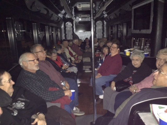 A group of people are sitting on a bus