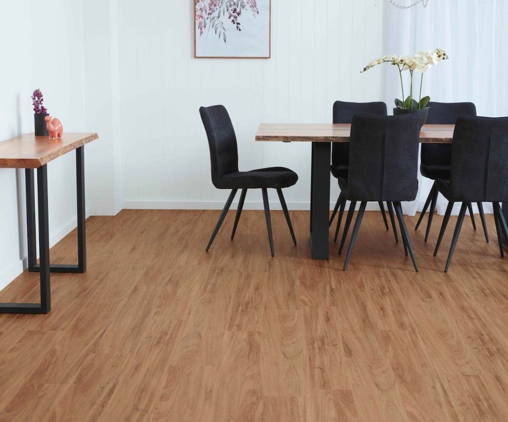 Dining Room With a Wooden Table and Black Chairs on a Wood-grain Floor — AGM Flooring & Tiling in Hidden Valley, QLD