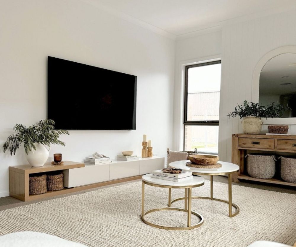 A Modern Living Room With a Mounted TV, a Light-coloured Rug, and Coffee Tables — AGM Flooring & Tiling in Hidden Valley, QLD