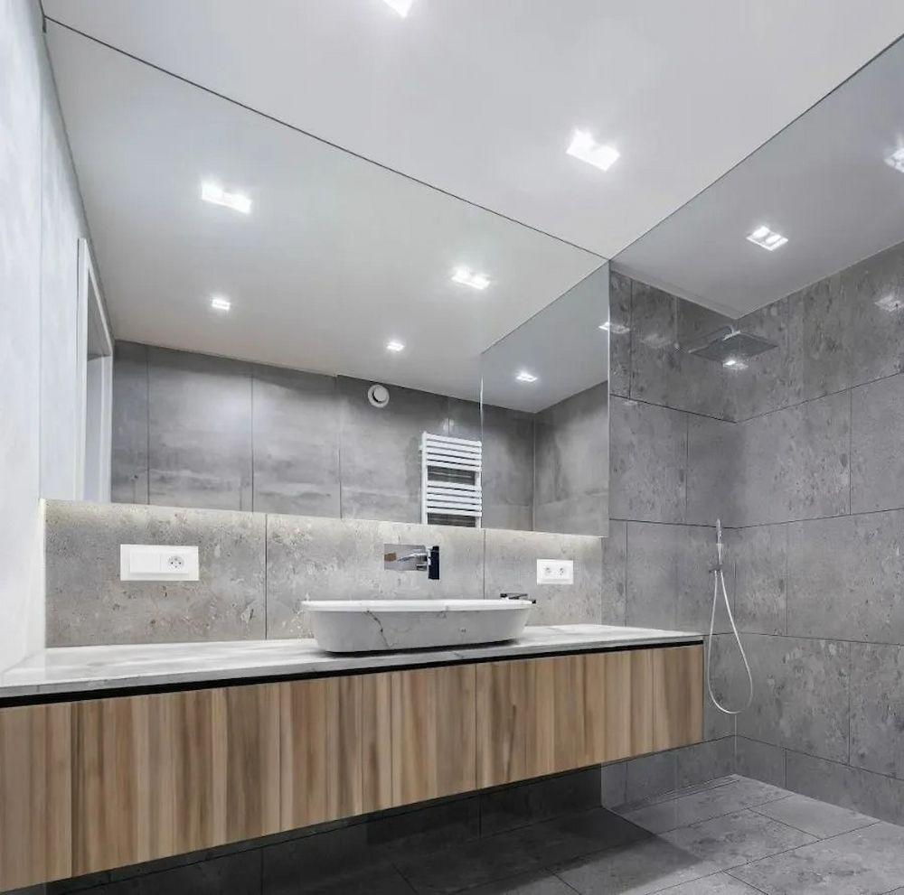 Modern Bathroom With a Floating Wooden Vanity, and Grey Tiled Walls — AGM Flooring & Tiling in Hidden Valley, QLD
