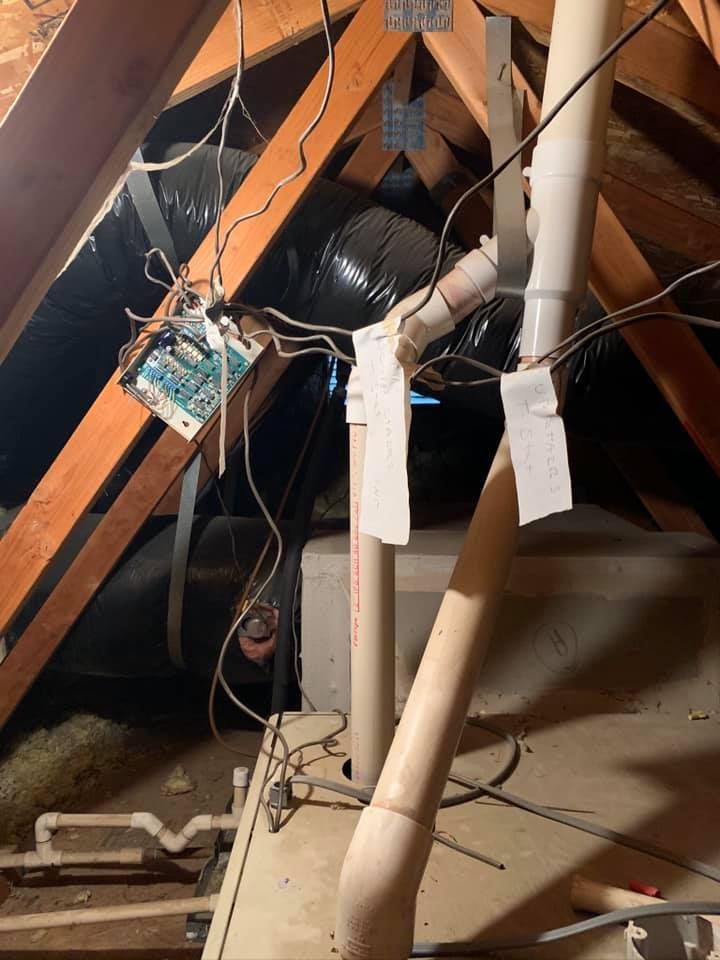 Exposed attic wiring and ductwork before HVAC upgrade by RPM HVAC Service Inc.