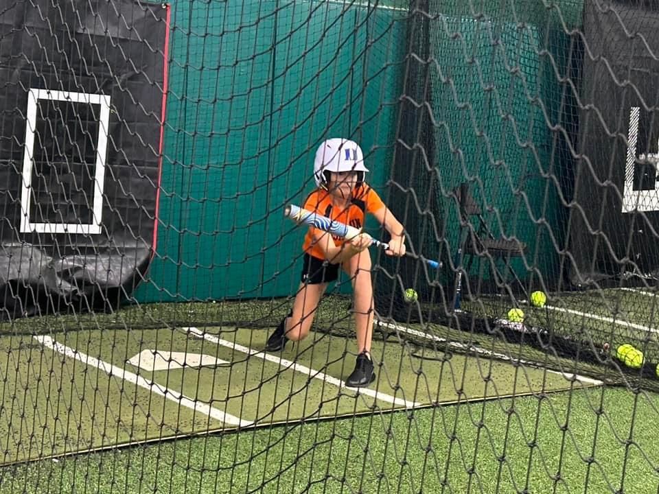 A young girl is swinging a bat at a softball — Elkton, MD — Maryland Legends Baseball
