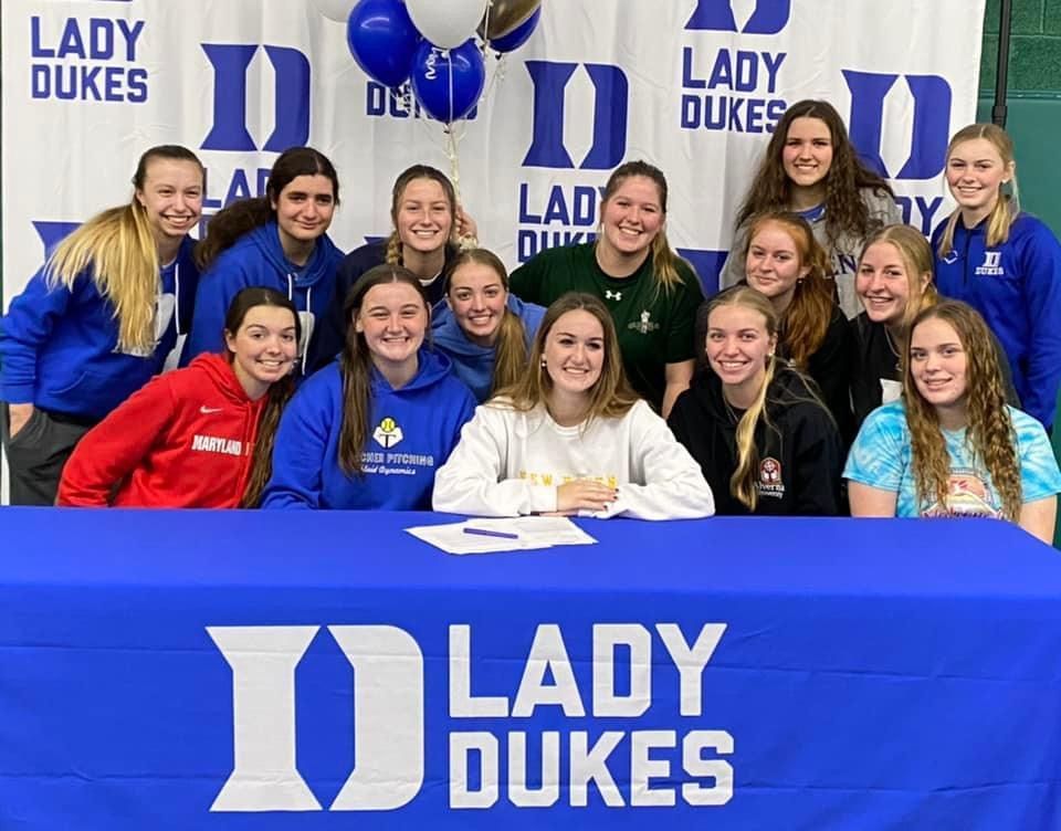 A group of girls are posing for a picture in front of a Lady Dukes banner — Elkton, MD — Maryland Legends Baseball