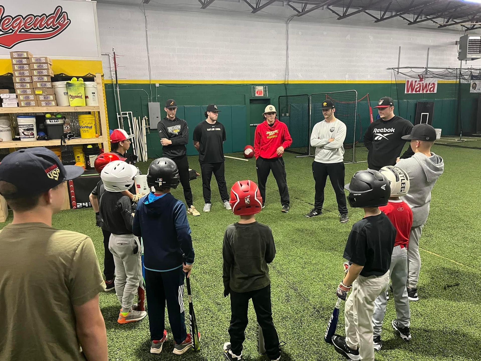 A group of young boys are standing in a circle on a baseball field — Elkton, MD — Maryland Legends Baseball