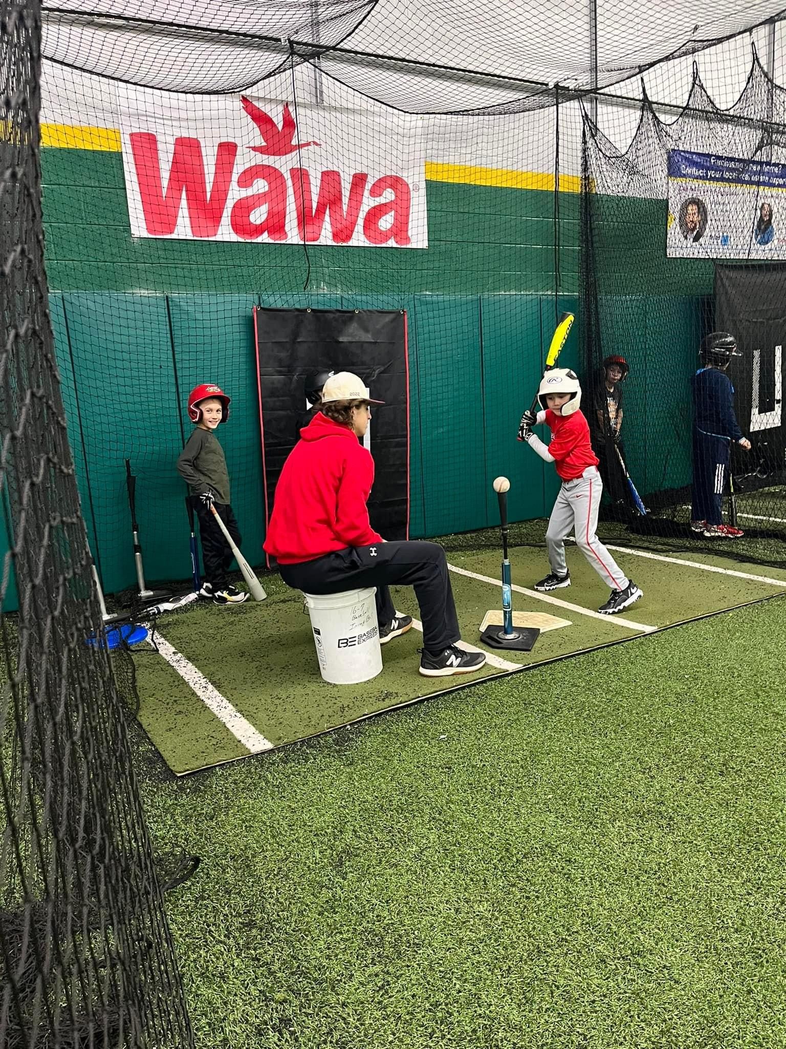 A group of young boys are playing baseball in a cage — Elkton, MD — Maryland Legends Baseball