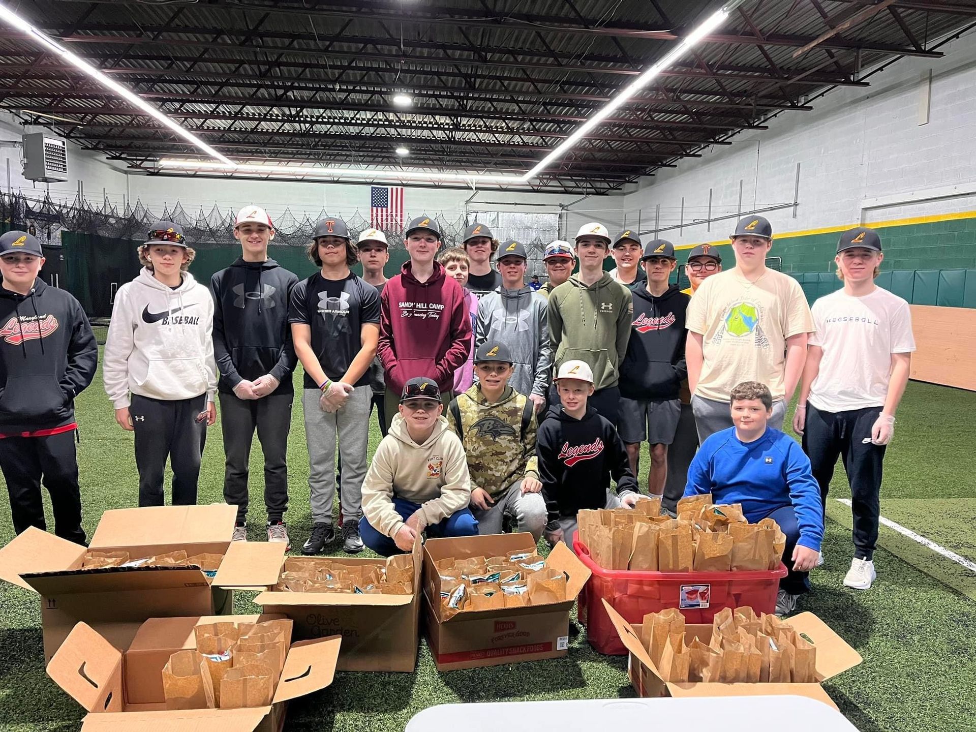 A group of people are posing for a picture in a warehouse — Elkton, MD — Maryland Legends Baseball