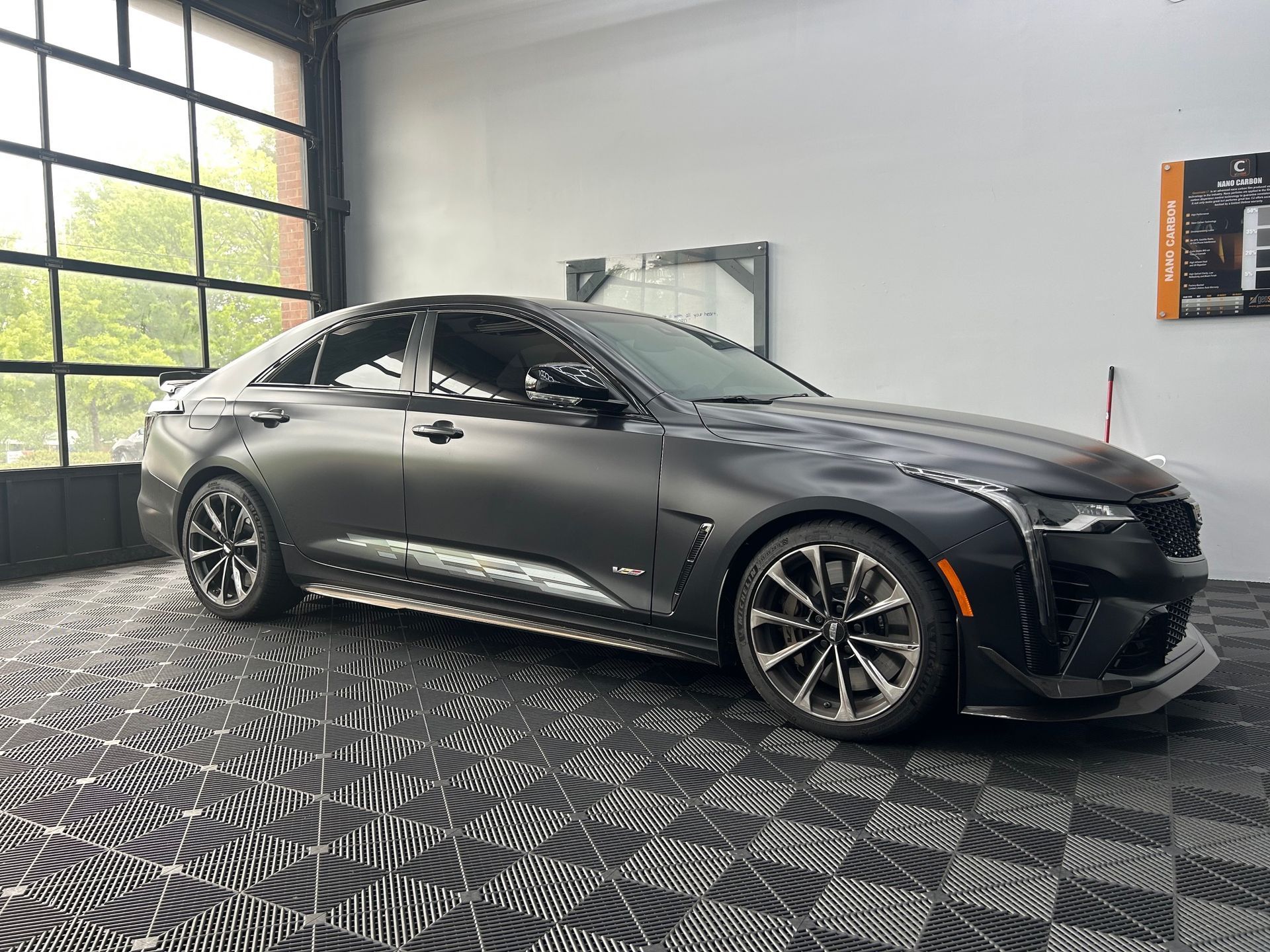 A red pickup truck is parked in a garage.