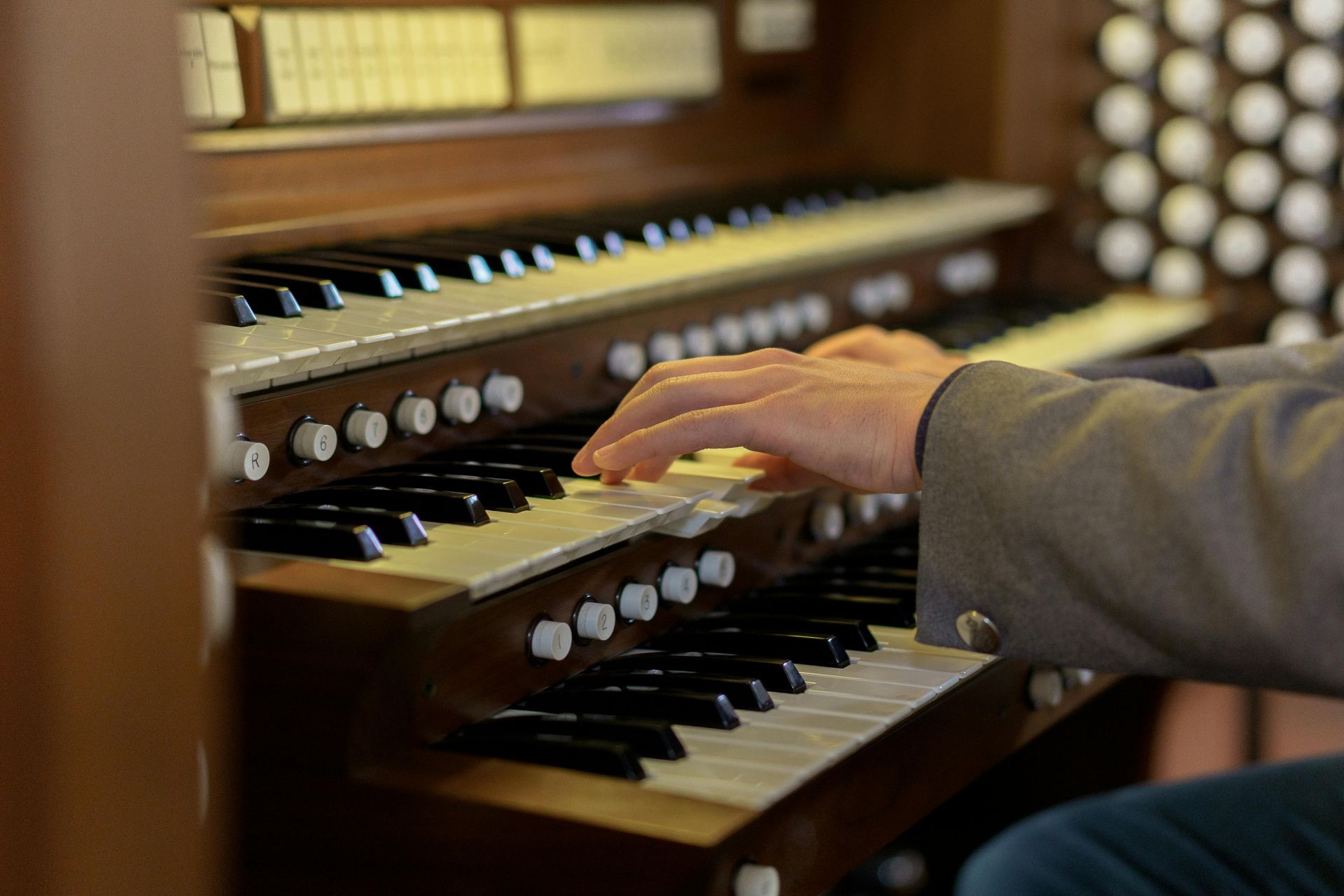 A woman is playing an organ in a church.
