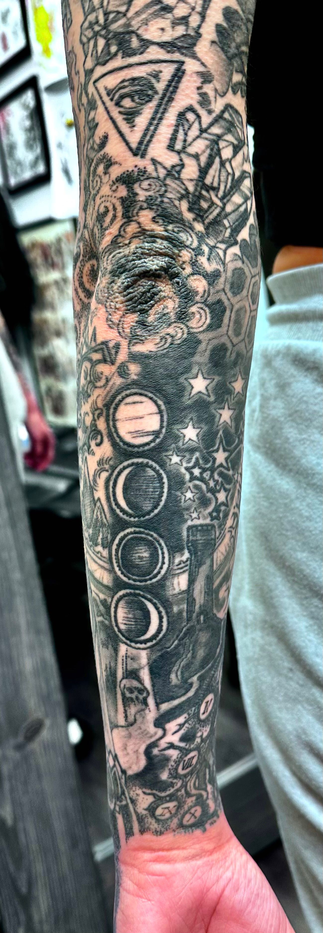 Cosmic sleeve with symbols tattoo