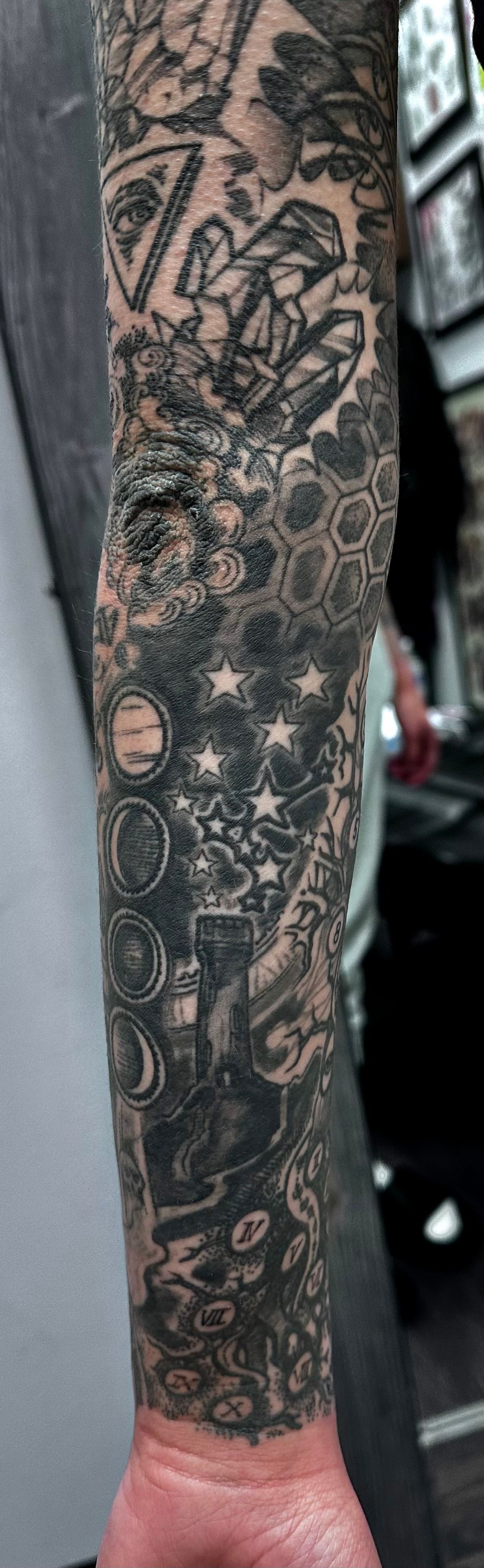 Cosmic sleeve with symbols tattoo