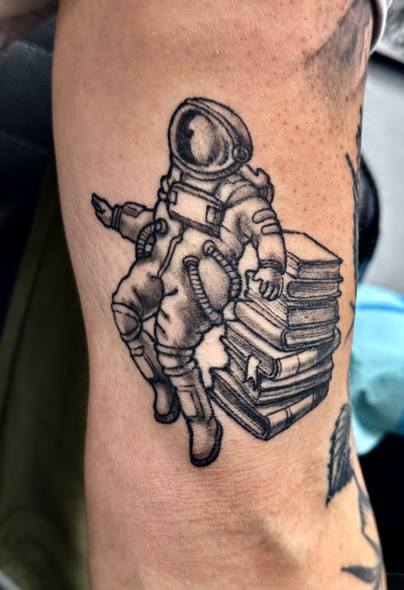 Book Stack with Astronaut Tattoo