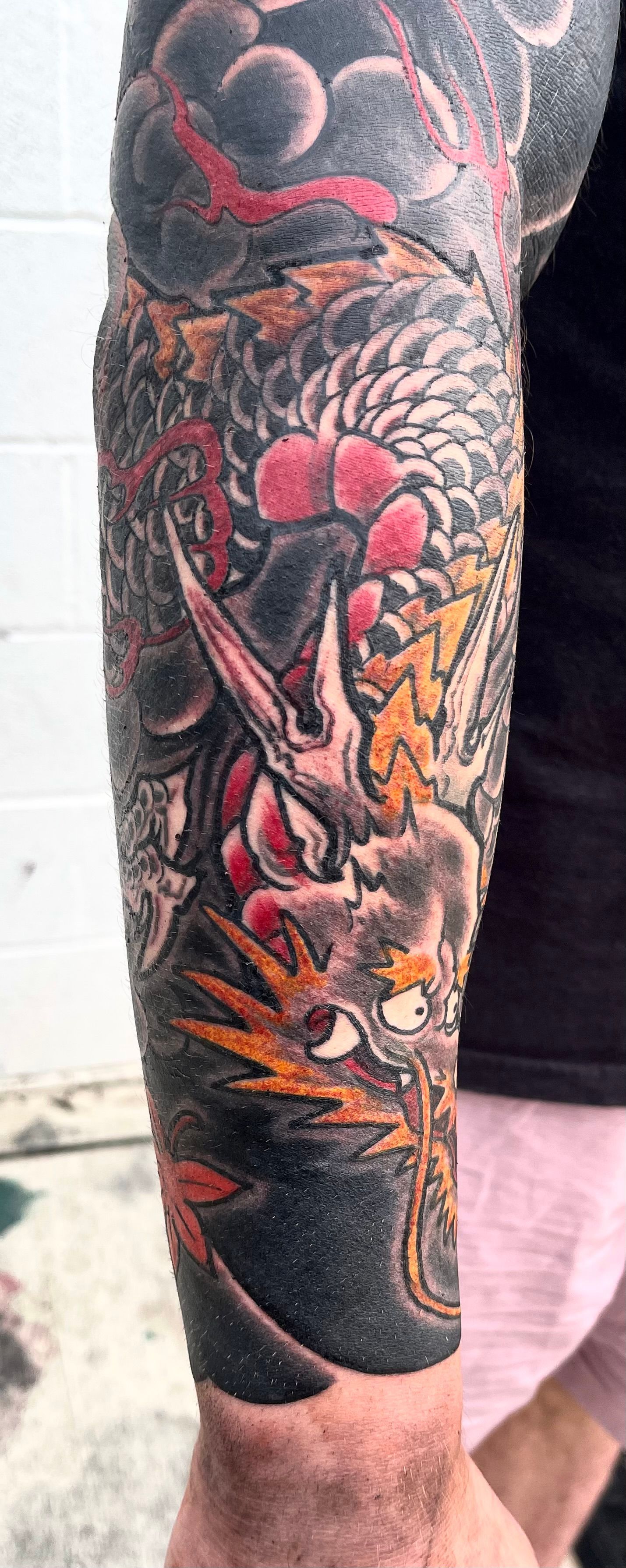 Dragon in black, red and yellow with heavy wind tattoo