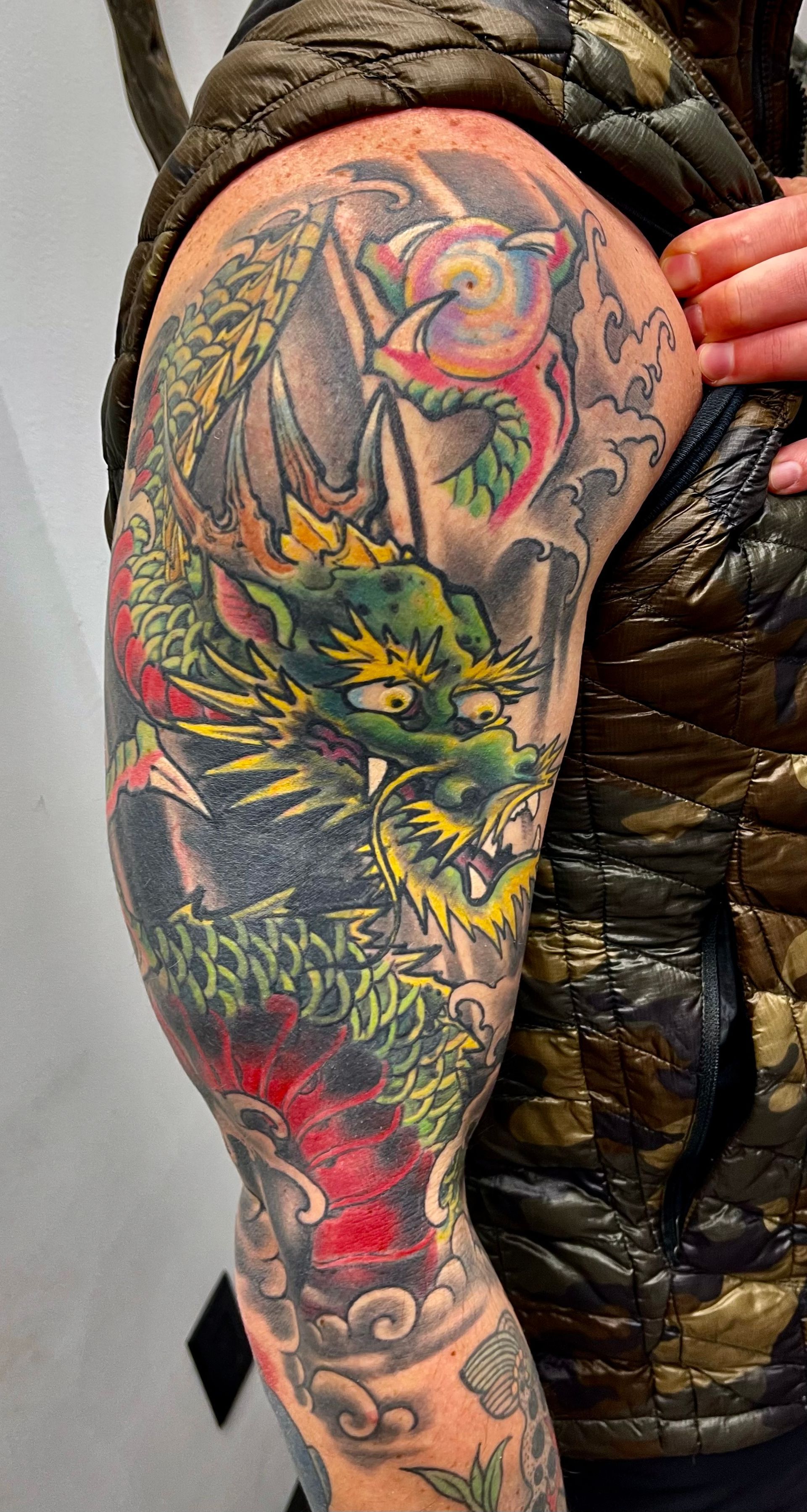 Green and orange dragon tattoo