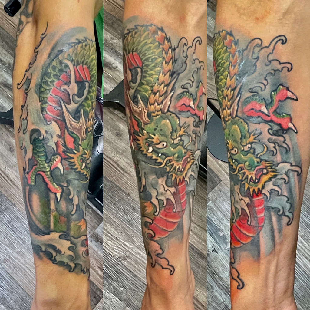 Olive and gray dragon in water tattoo