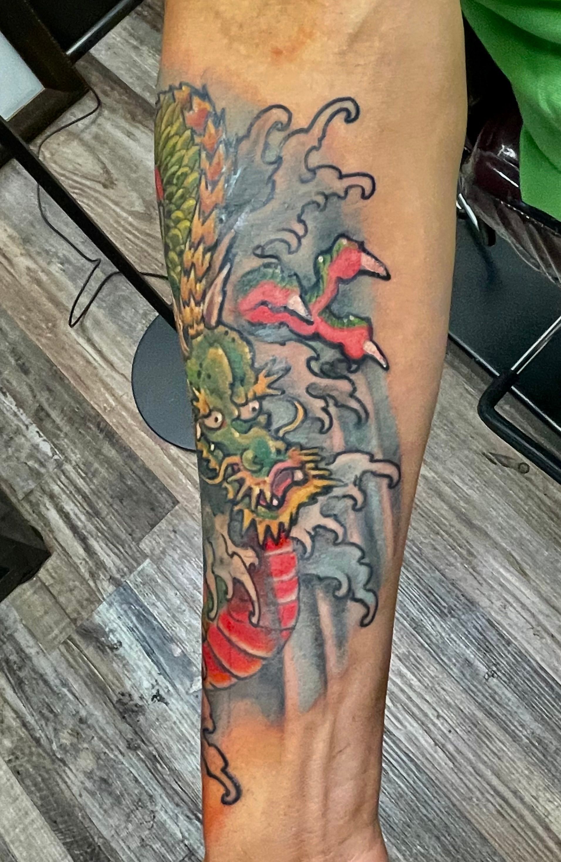 Colorful olive and gray dragon tattoo