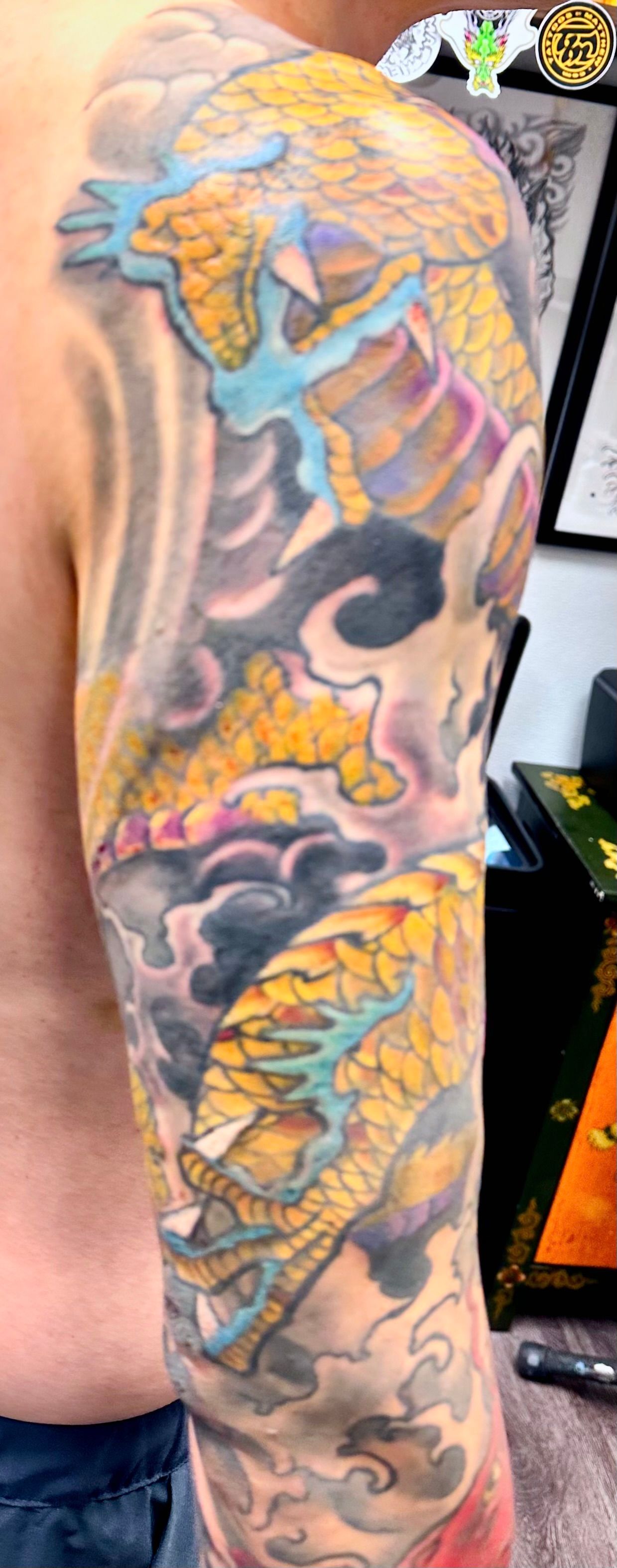Golden dragon in waves tattoo