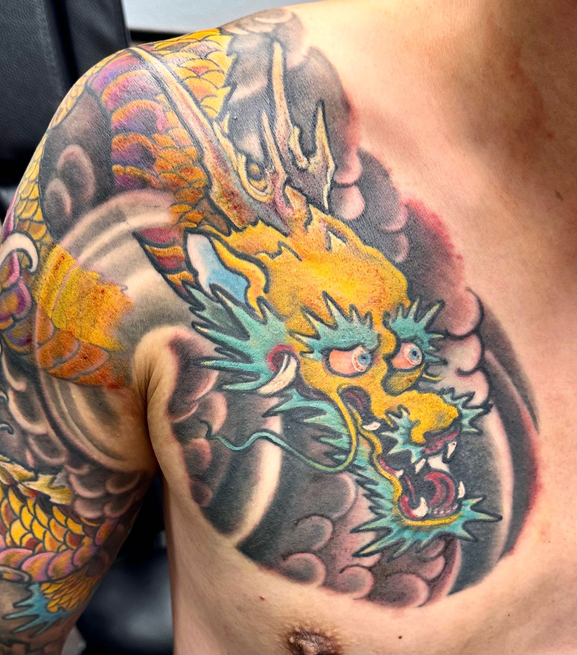 Golden dragon in waves tattoo