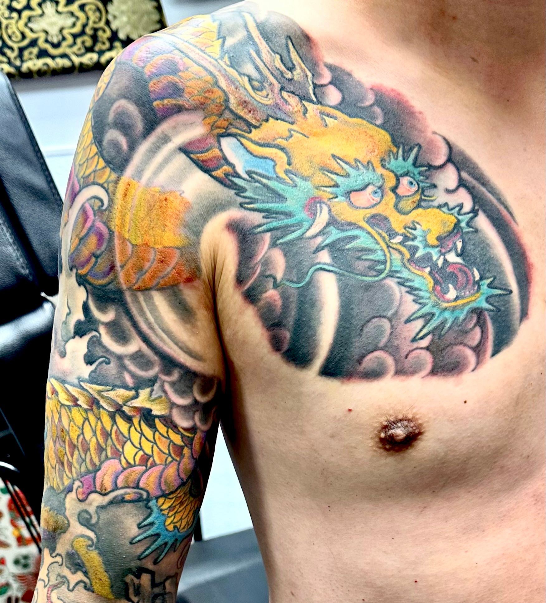 Golden dragon in waves tattoo