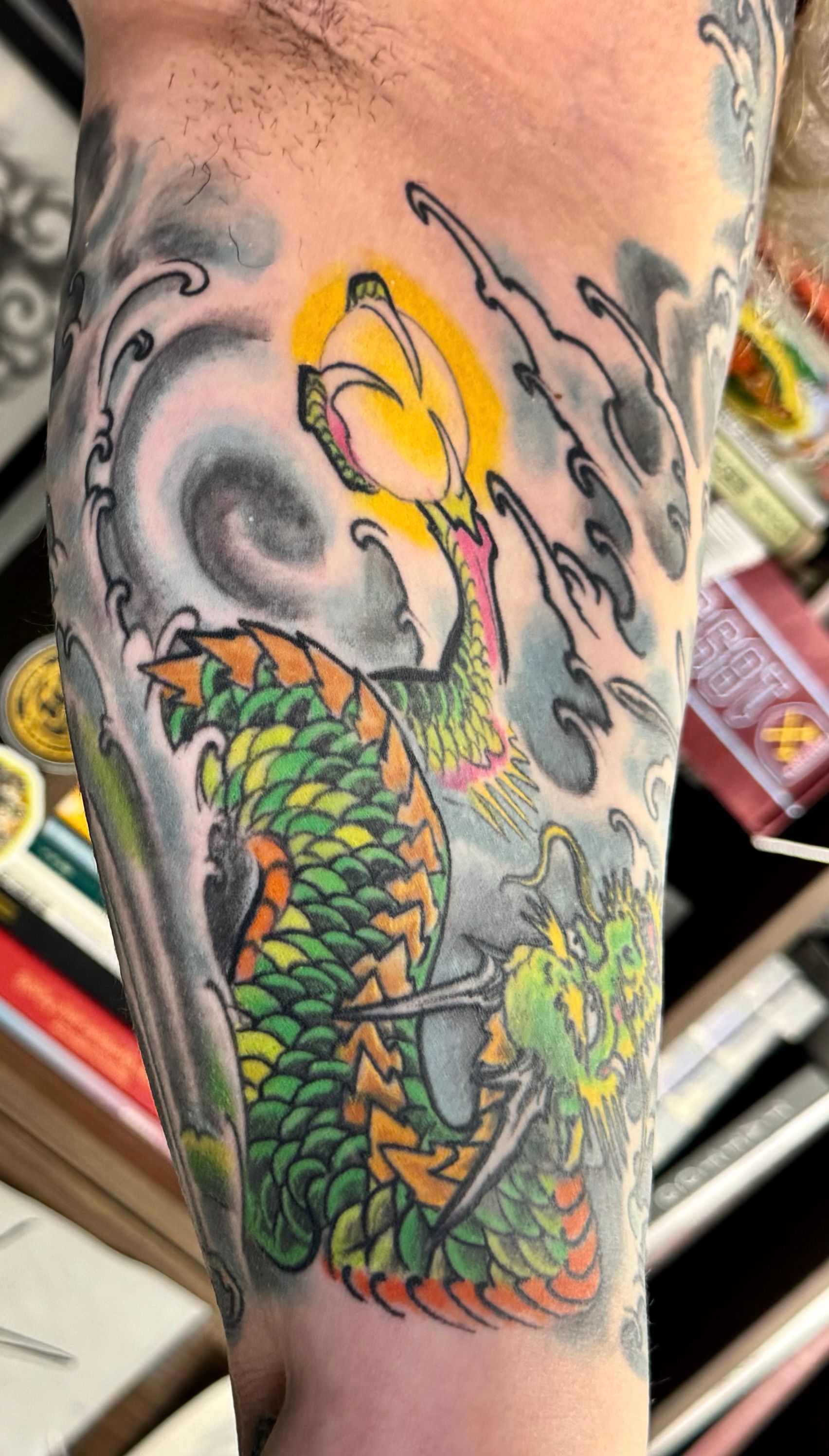 Green and orange dragon tattoo
