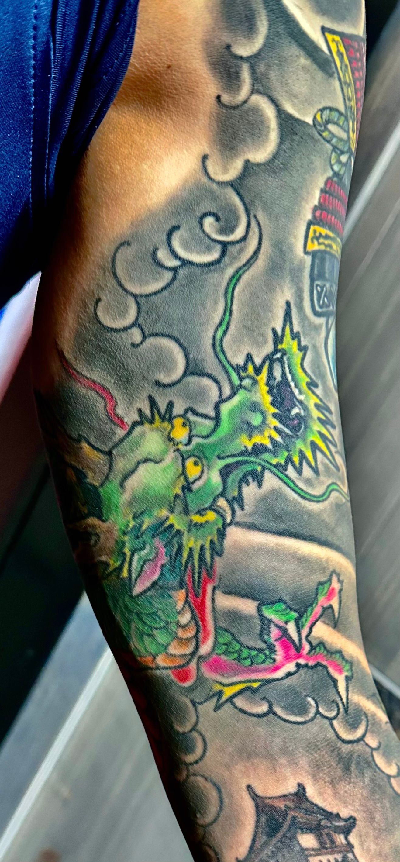 Green and orange dragon tattoo