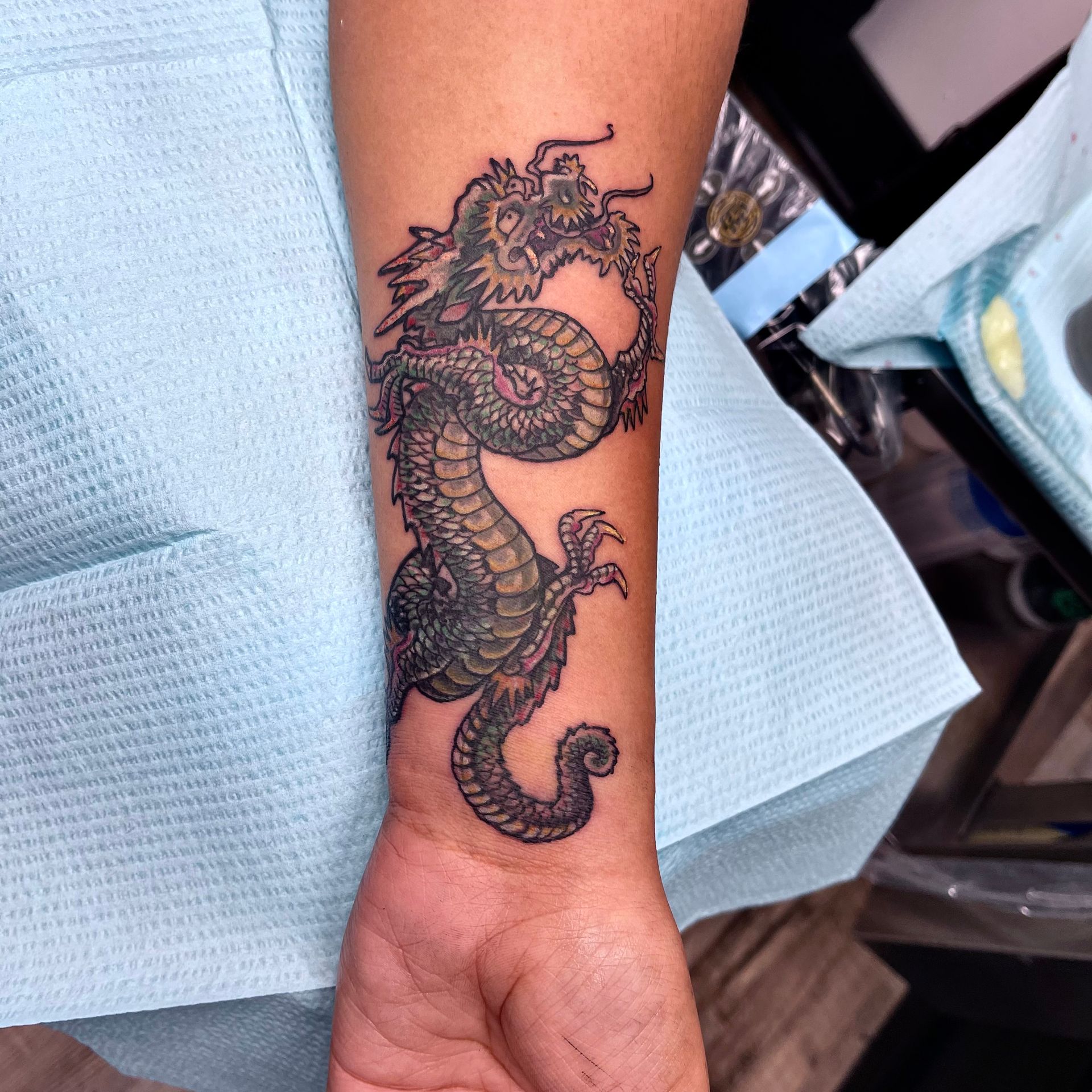 Small olive dragon tattoo