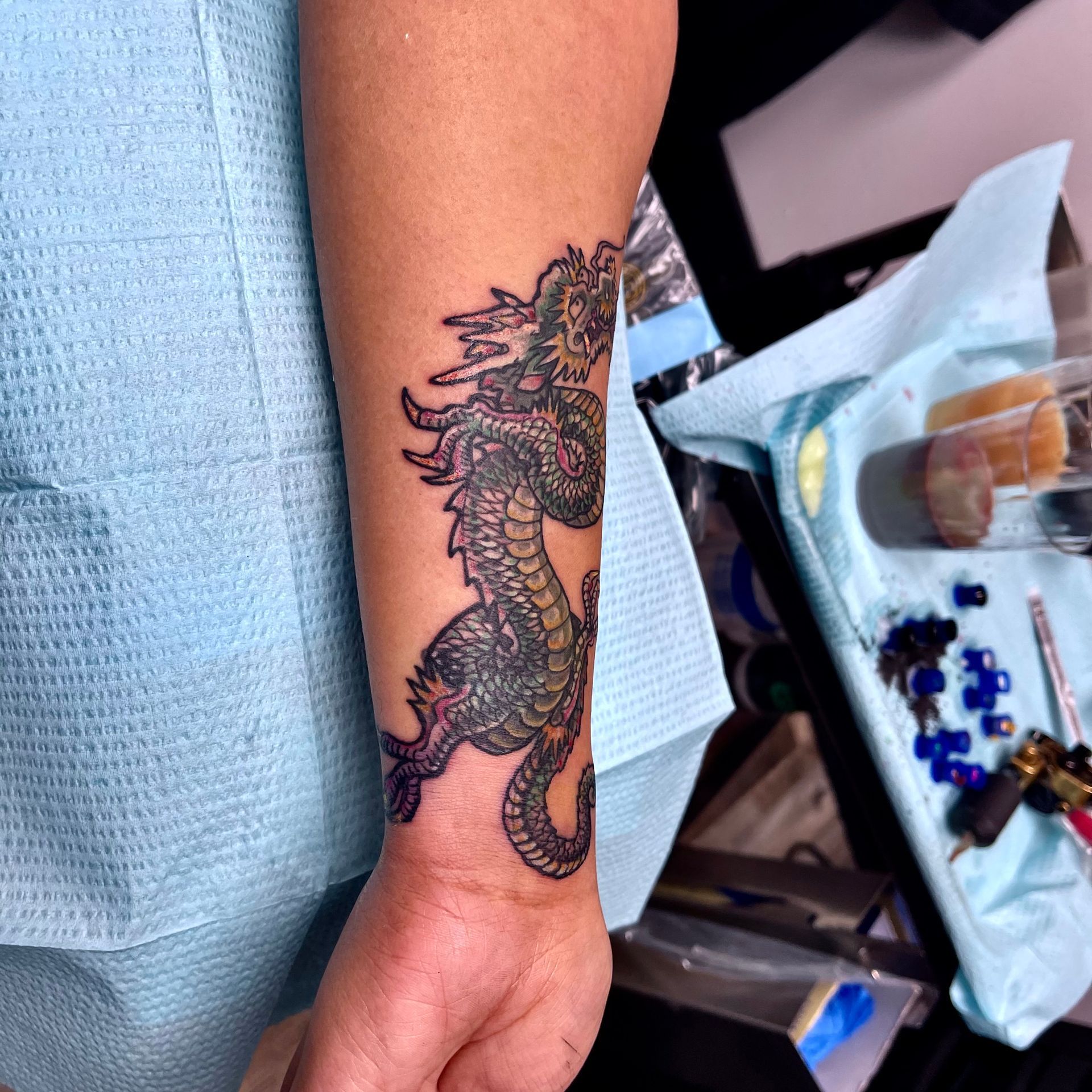 Small olive dragon tattoo