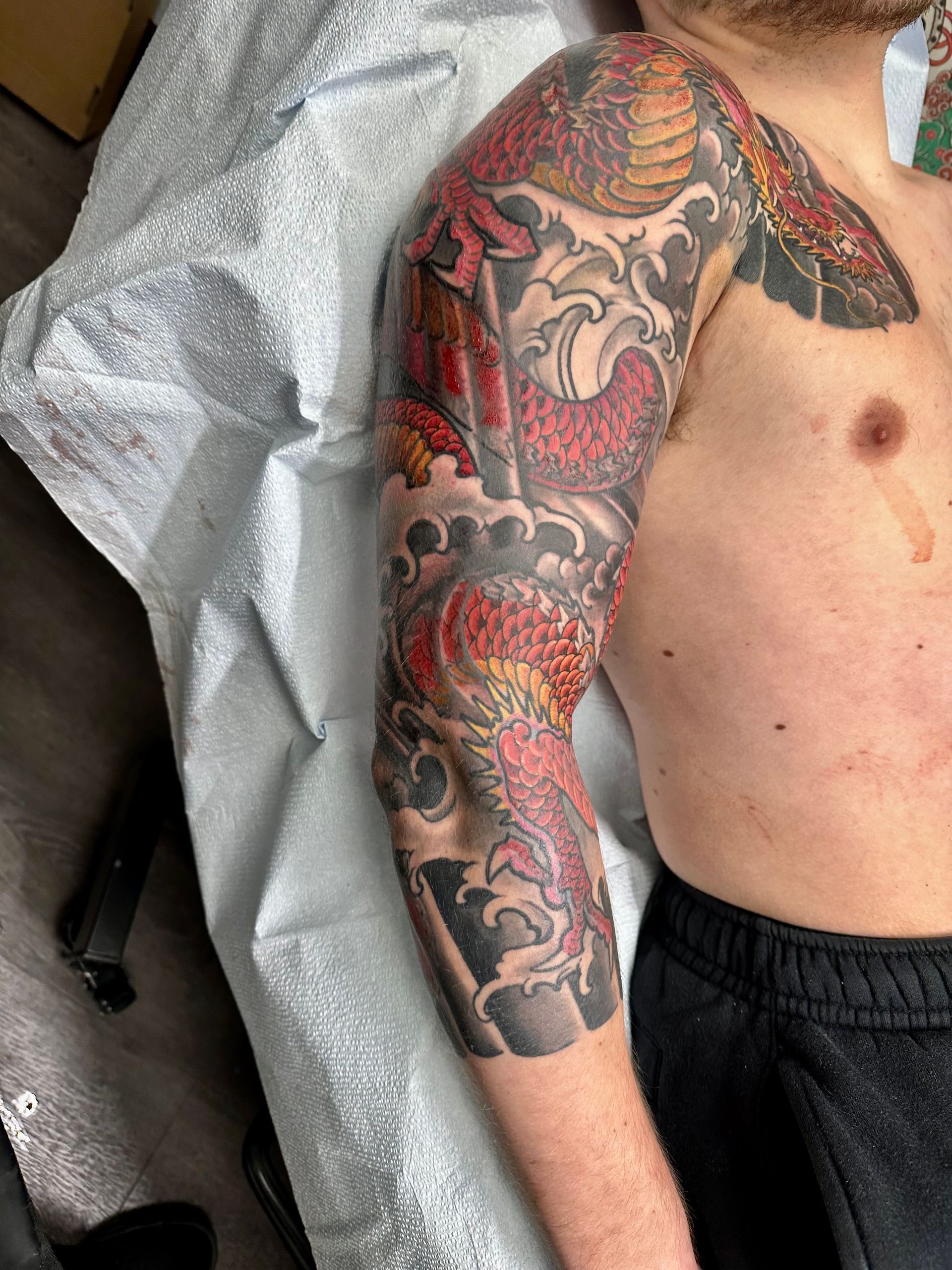 Red dragon sleeve tattoo