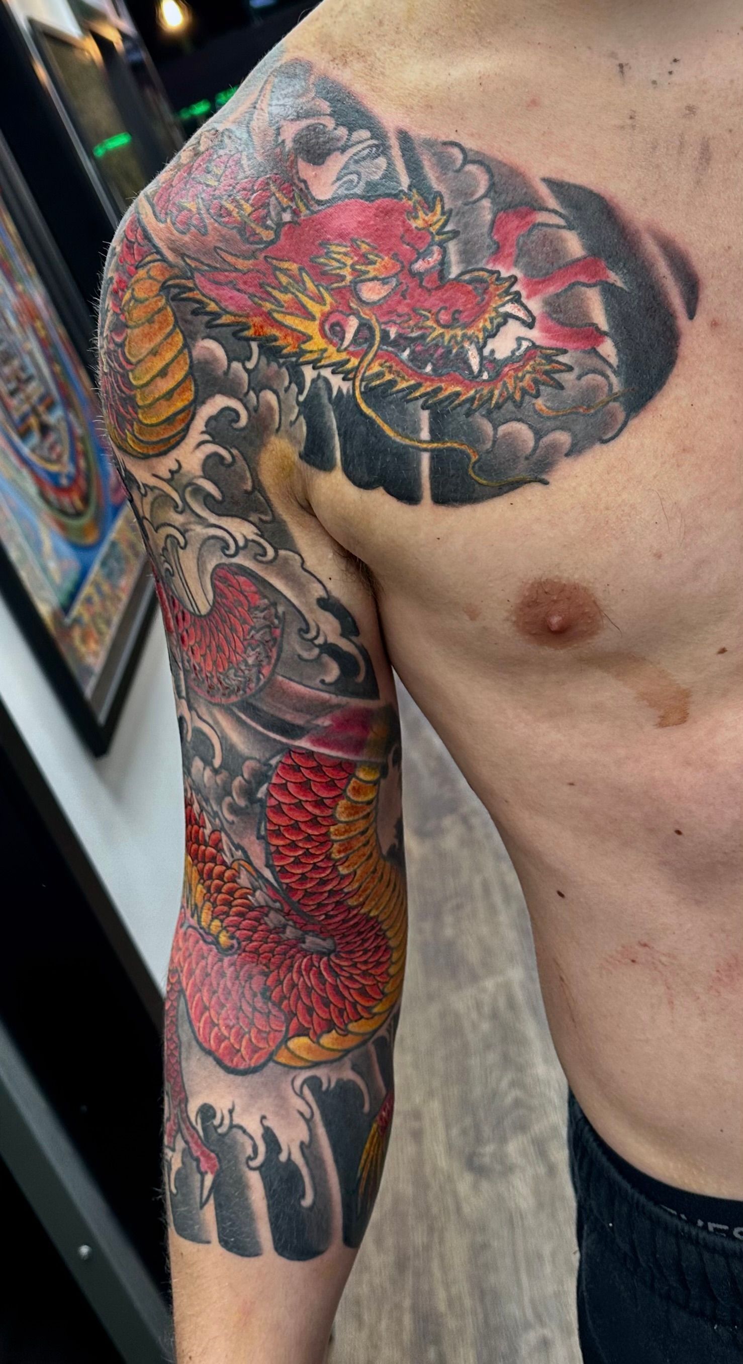 Red dragon with waves tattoo 