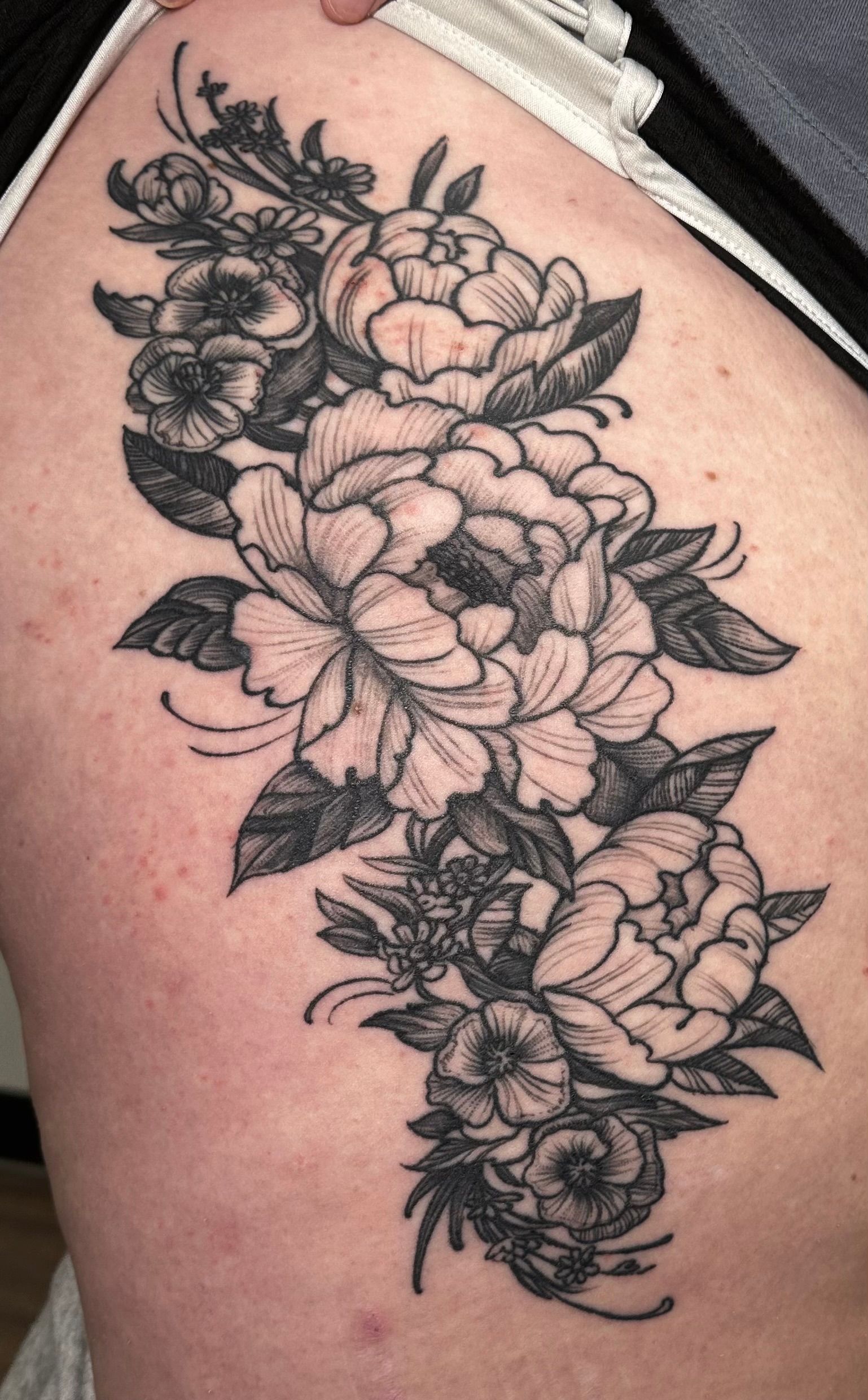 Flowers tattoo on thigh