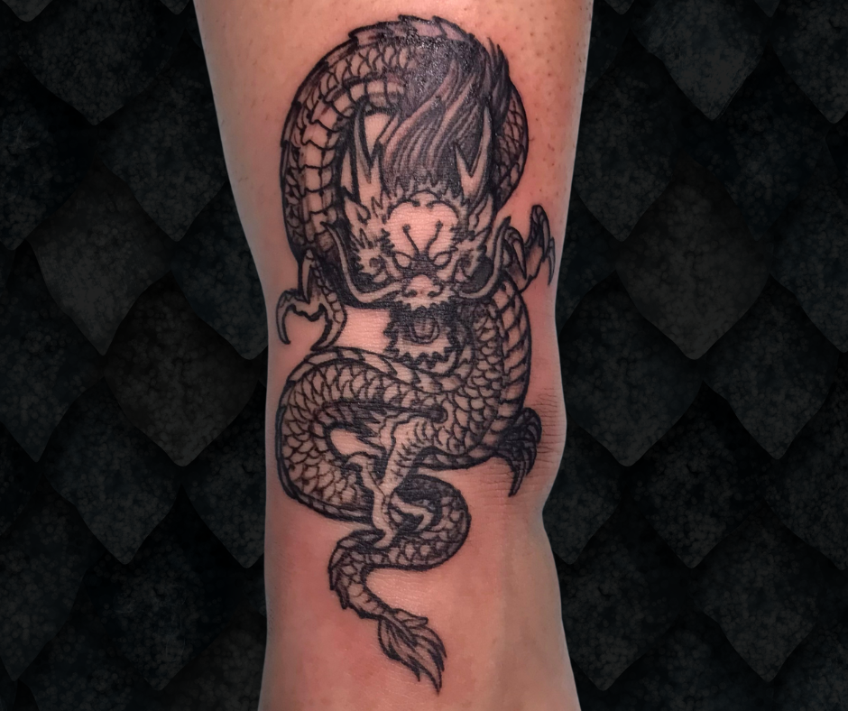Black & gray dragon on top of ankle