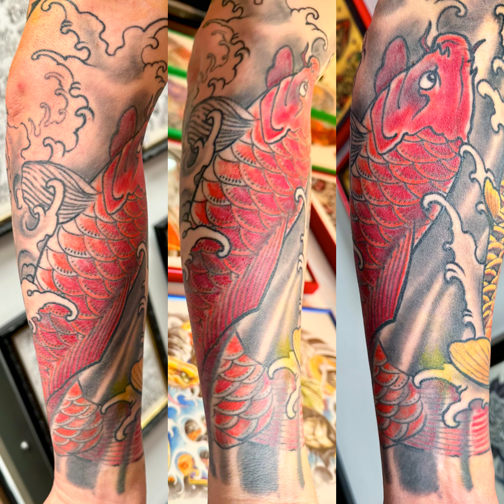 Red koi in waves sleeve tattoo