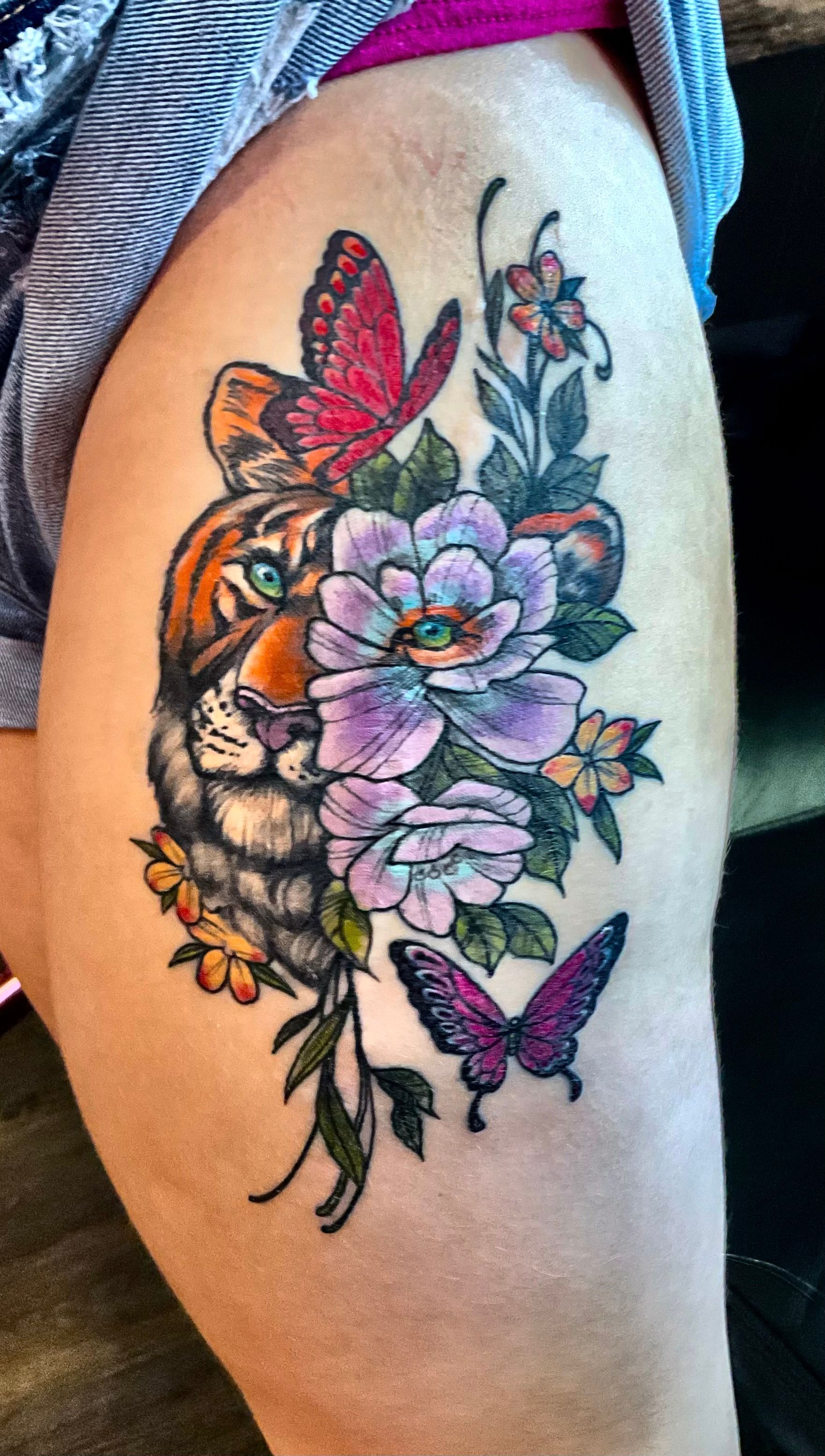 Lion and butterfly tattoo used to cover scar